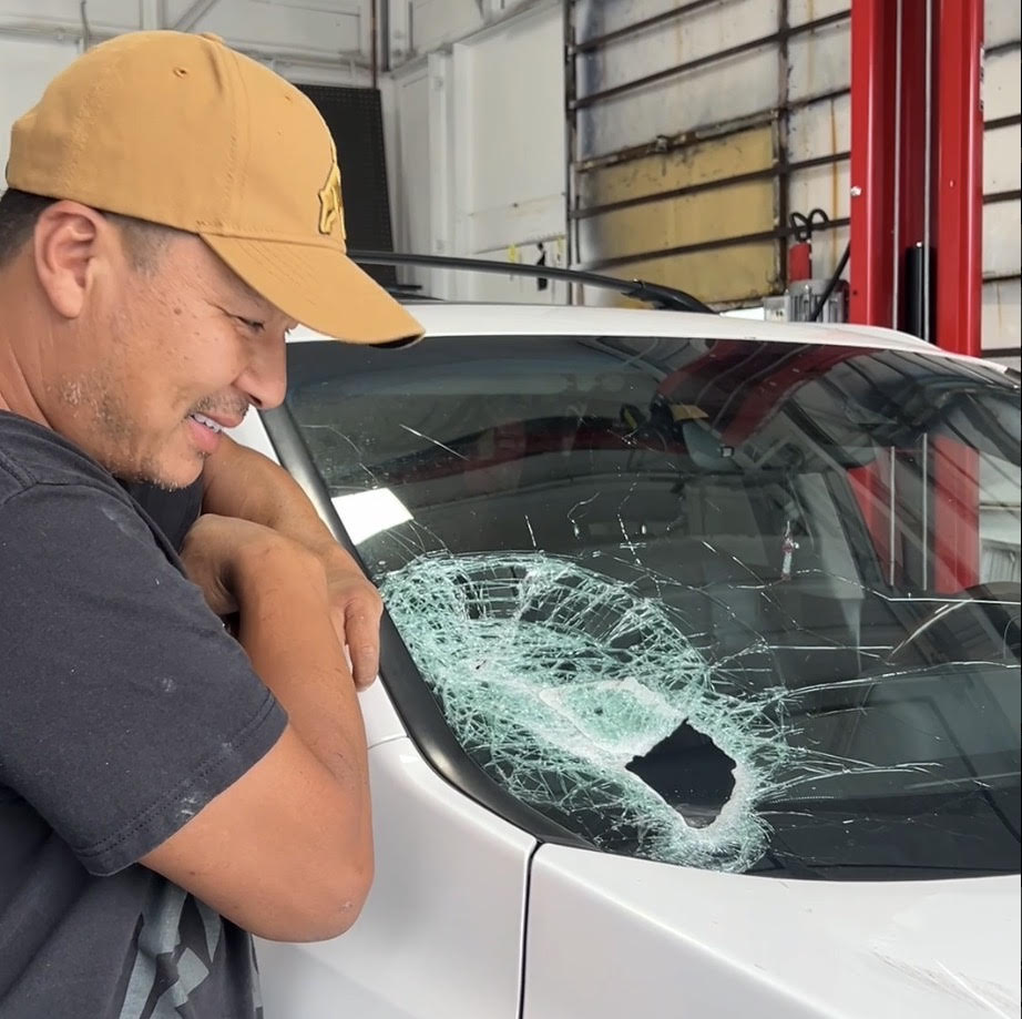 VanGo Auto Glass technician inspecting a damaged windshield in the Seattle shop